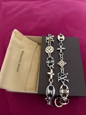 Louis Vuitton Silver Logo Charm Chain Belt on Pink Background